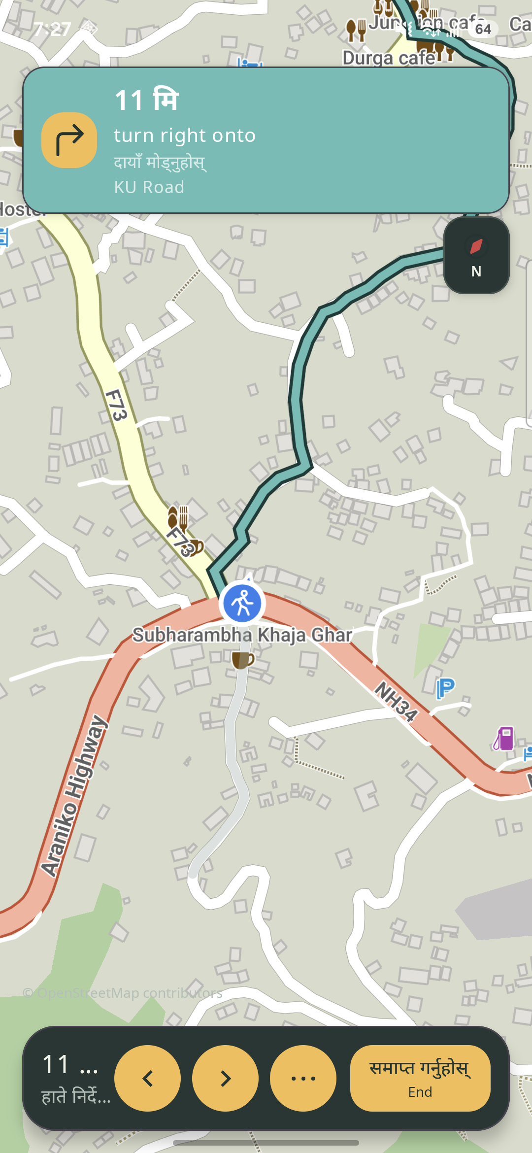 Nepali turn guidance above a map route in the app